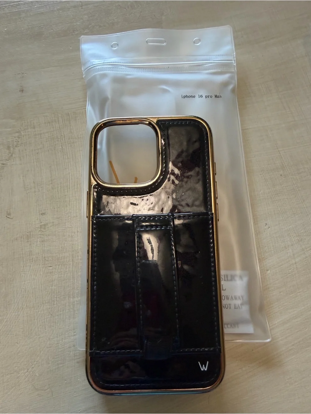 Sleek Black Wallet Phone Case with Gold Trim for iPhone 16 Pro Max